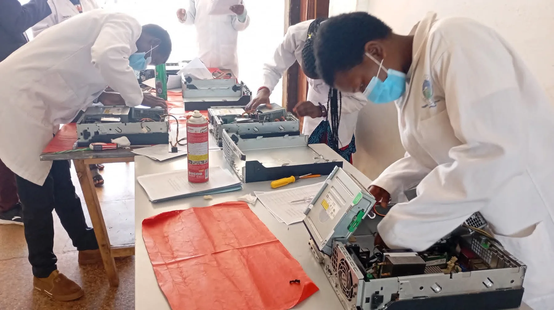 Students undertaking practical computer technology training